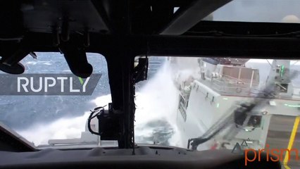 Denmark- Helicopter braves extreme North Sea conditions to land on moving war ship
