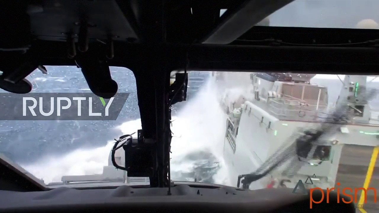 Denmark- Helicopter braves extreme North Sea conditions to land on moving war ship