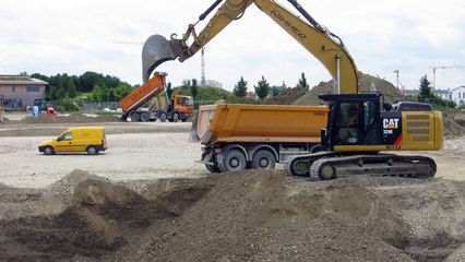 CAT 329E loading trucks with gravel