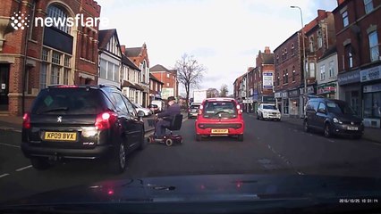 Man on mobility scooter almost hit by car