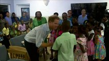 Prince Harry plays with children in Barbados