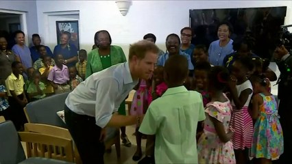 Prince Harry plays with children in Barbados