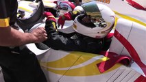 Playmate rides in F1 car with Mario Andretti