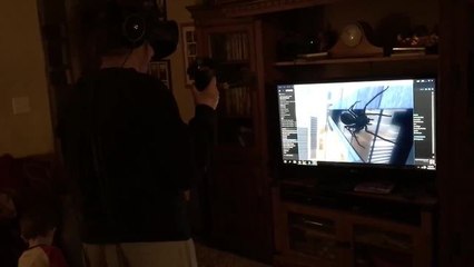 Girl tries out VR game, crashes into TV stand