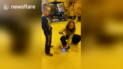Girl pulls out her younger brother's tooth using a remote-control car
