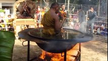 A Buddhist monk meditating in a hot oil container