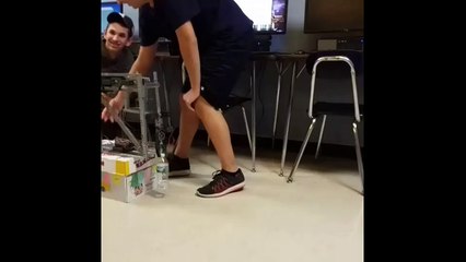 High school students build robot that perfectly flips water bottle