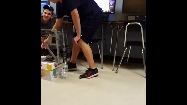 High school students build robot that perfectly flips water bottle