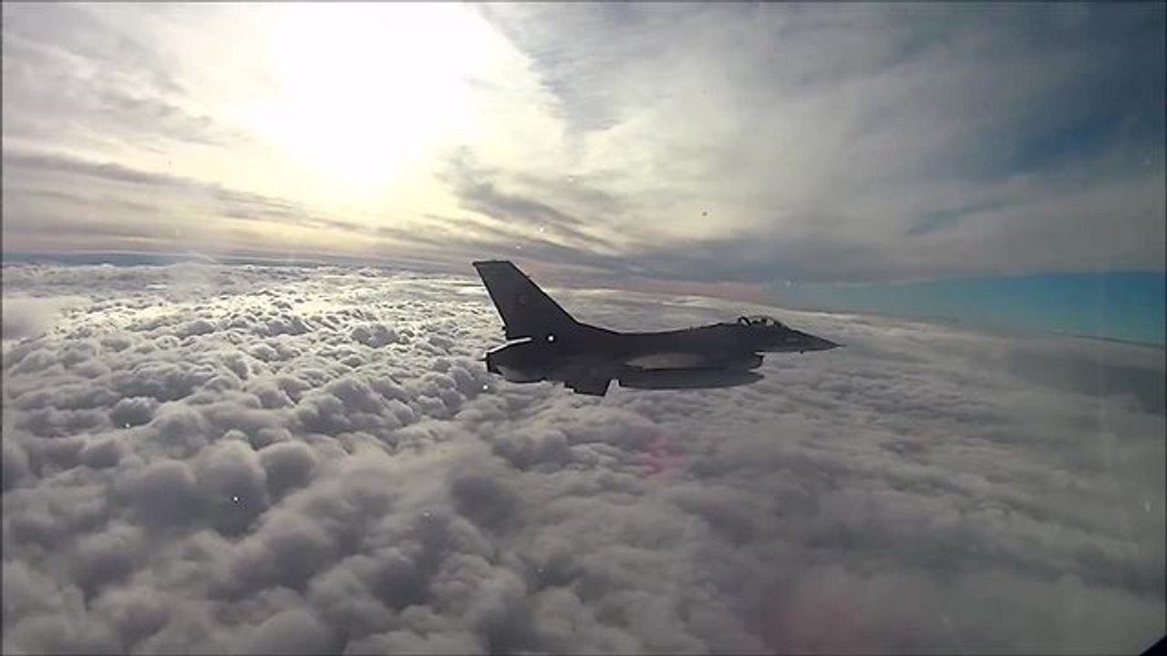 Cockpit view of F16 Fighting Falcon above a sea of clouds