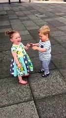 Babies kissing each other.