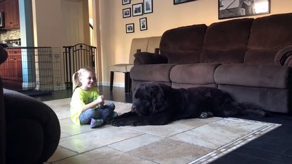 Little girl and dog share secret language together