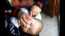 Chinese Ear Cleaning (87) A mother cleaning her son's ears