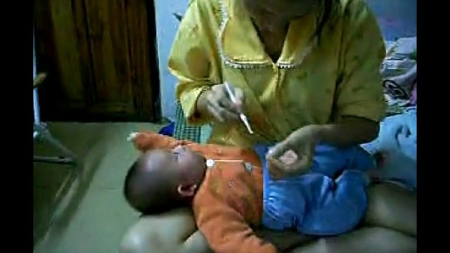 Chinese Ear Cleaning (89) A mother cleaning her daughter's ears