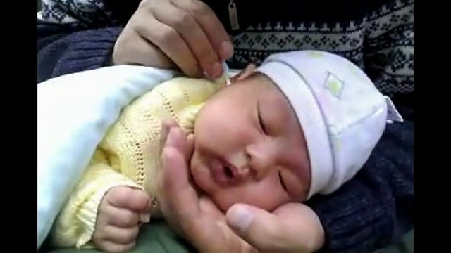 Chinese Ear Cleaning (97) A new born baby enjoying a relaxing ear cleaning session