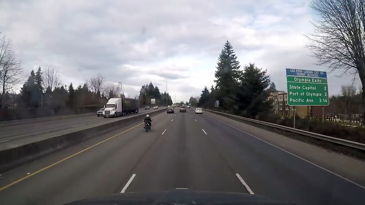 Intense helmet cam shows how a motorcyclist ended up on the trunk of a car