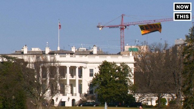 Greenpeace Protestors Climbed a Crane to Hang a 'Resist' Banner