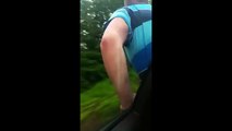 Idiot car passenger pushes cyclist off his bike at high speed!