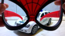 The police car behind the amazing spider man glass.