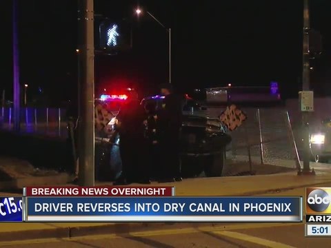 Driver reverses into dry canal in Phoenix