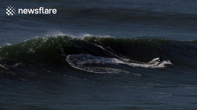 Intrepid surfers ride giant waves in Nazare, Portugal