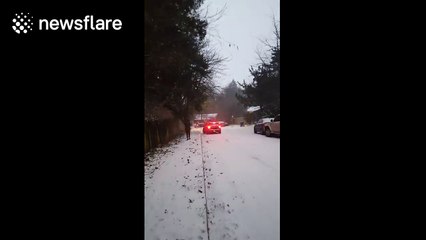 Mini Cooper crashes into parked car after trying to climb icy hill