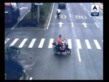 Woman on scooter has lucky escape as truck crashes into her