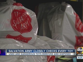 Volunteers check donated Christmas toys for hazards