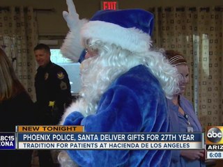 Phoenix police officers bringing their own jolly man in blue to spread cheer