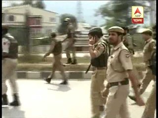 Policemen conducting searches and patrolling the streets of Hyderpora after the attack.