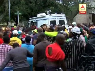 People paying homage to Nelson Mandela through song, dance.
