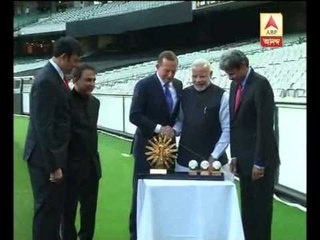 PM Modi and Australia PM pose with world cup trophy at melbourne cricket ground