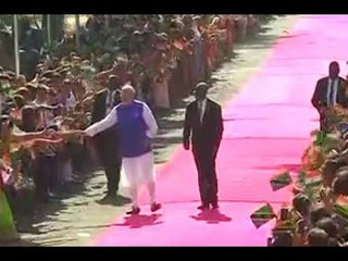 Children wave India and Tanzania flags as they welcome PM Narendra Modi in Dar es Salaam