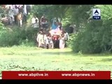 Jabalpur: People walk through swollen lake to perform a funeral