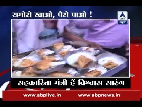 Cooperation minister Vishwas Sarang distributes tea, samosas to people queued up outside b