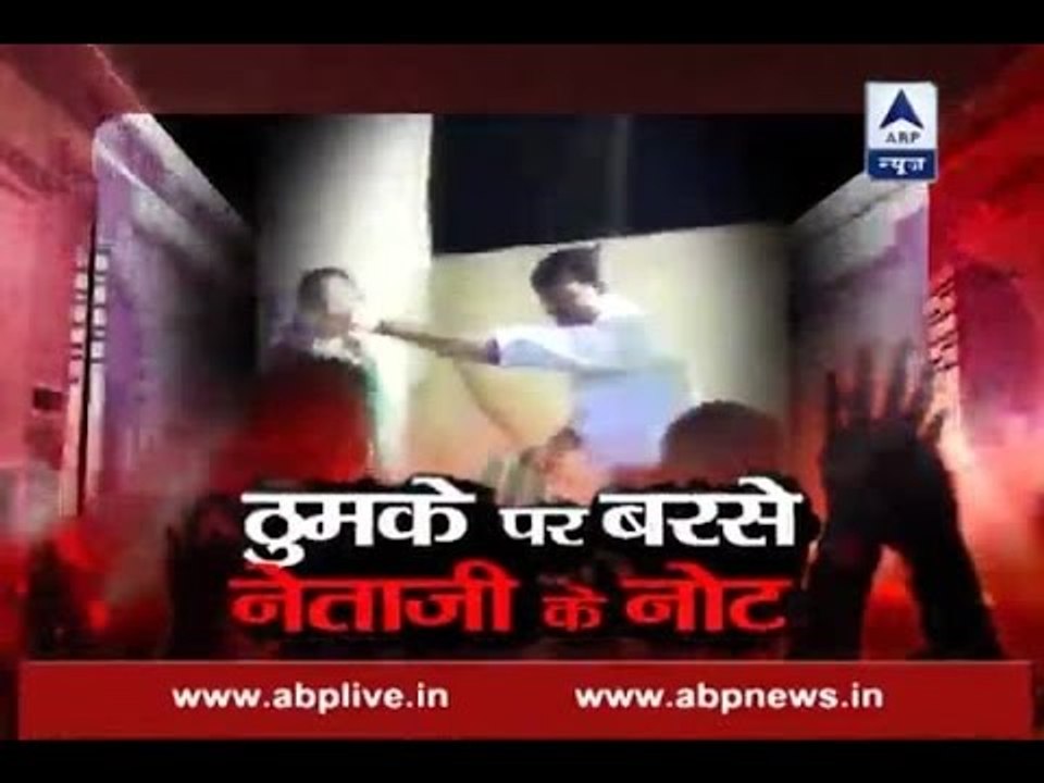 Sansani: Political leader showers new currency notes on a dancer at marriage