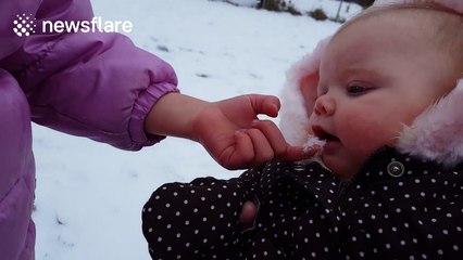 Baby eats snow for the first time and loves it