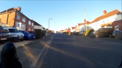 Driver leans out of car window and attempts to push cyclist off!