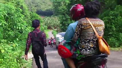 A woman driving on a steep uphill road