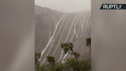 Heavy Rainfall Causes Waterfalls from Ayers Rock