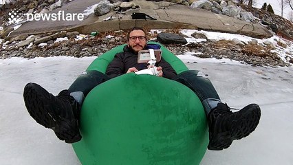 YouTuber enjoys inflatable seat on frozen lake