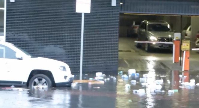 Garbage Floats Down Floodwaters in Melbourne Street