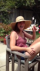 Backyard blue jay snags peanut off girl's hat