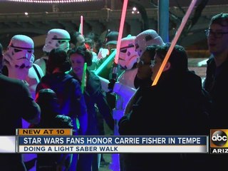 Fans gather to remember Carrie Fisher with light saber walk
