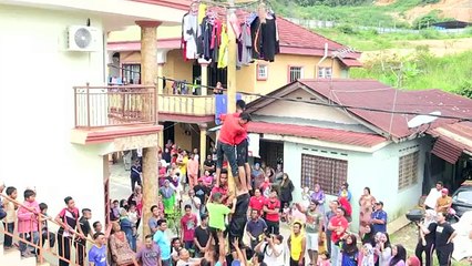 Malaysian village hosts greasy pole competition