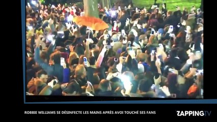 La réaction écœurée de Robbie Williams après avoir touché ses fans fait le buzz (Vidéo)