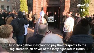 Horns blare as Polish trucker buried
