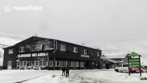 People enjoy sledding on the snow in Glenshee, Scotland