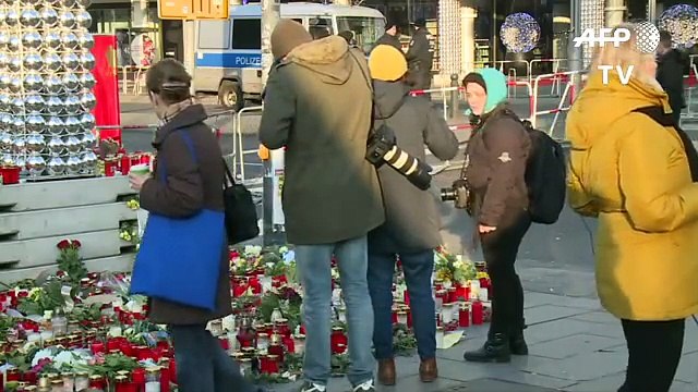 People in Berlin remember victims of market attack