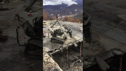 Engin de démolition suspendu à une grue