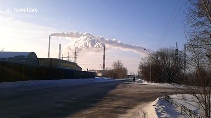 Power plant chimney smoke columns appear to fly in different directions